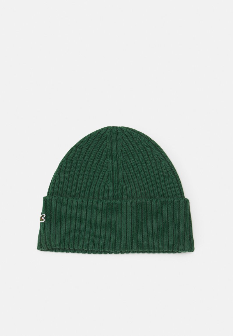 Green knitted beanie with ribbed texture, featuring a folded cuff and a small embroidered logo on the side.