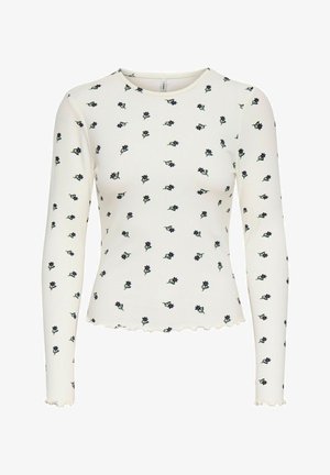 Langsleeve ribbed top in off-white met verspreide marineblauwe bloemenprint. Heeft een geschulpte zoom en zachte, gestructureerde stof.