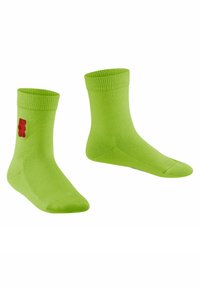 Grüne Baumwollsocken mit geripptem oberen Rand, versehen mit einem roten Gummibärchen-Logo an der Seite. Glatte Textur, knöchellanges Design.