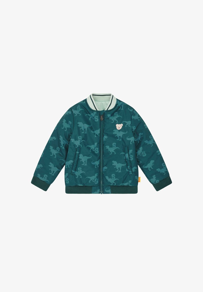 Veste bomber pour enfants en bleu sarcelle avec un motif de silhouettes de dinosaures, fermeture éclair à l'avant, poignets côtelés et une petite écusson ours en peluche sur la poitrine.