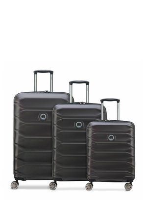 Black hardshell luggage set of three sizes, featuring a textured surface, telescoping handles, and four spinner wheels for mobility.