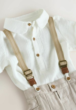 Világos színű len rövid ujjú ing gallérral, két fa gombbal és bézs vállpántokkal, bőr részletekkel.