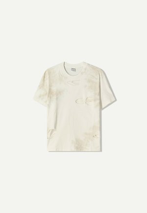 Cream-colored cotton t-shirt with tie-dye pattern and distressed details, including holes and frayed edges, offering a relaxed fit.