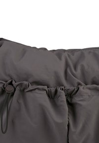 Gray nylon drawstring bag with gathered top and a toggle closure. The surface is smooth with a slightly shiny finish.