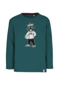 Teal pitkähihainen paita, jossa on graafinen kuva kruunusta olevasta hahmosta hupparissa, joka pitää koriottopalloa ja jossa on teksti "G.O.A.T.".