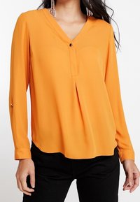 Orange, long-sleeve, V-neck blouse featuring a button detail at the front and pleating under the chest; smooth texture and relaxed fit.