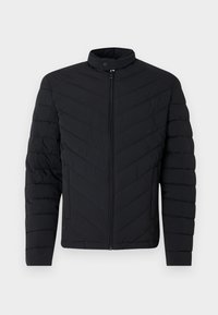 Jachetă puf subțire, de culoare neagră, cu guler înalt, model cu zig-zag, închidere cu fermoar complet și manșete ribdate. Design ușor, elegant.