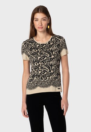 Maglione a maniche corte con un motivo floreale nero su uno sfondo beige, dotato di scollatura rotonda e orlo piatto.