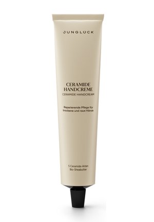 Jungluck Ceramide Handcreme in einer Tube mit schwarzem Deckel, gekennzeichnet zur Reparatur von trockenen und rauen Händen mit 5 Ceramidtypen und Bio-Sheabutter.