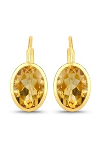 Boucles d'oreilles en ton or ornées de grandes pierres jaunes ovales facettées, à surface lisse et polie, avec un design incurvé et un crochet ouvert.