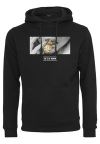 Černá mikina s kapucí, která má na přední straně grafiku s monochromatickým obrazem a zlatými akcenty. Obsahuje klokankovou kapsu a stahovací kapuci.