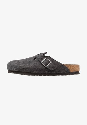 Gray felt slipper with a cork sole, featuring a strap and buckle detail. The upper has a soft texture and rounded shape.