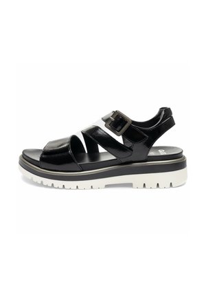 Black patent leather open-toe sandal with two straps, silver buckle, and thick white treaded sole.