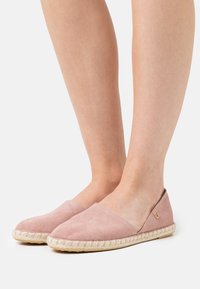 Różowe zamszowe espadryle z atłasową podeszwą z juty, charakteryzujące się niskim krojem i bocznymi wycięciami dla lepszej wentylacji.