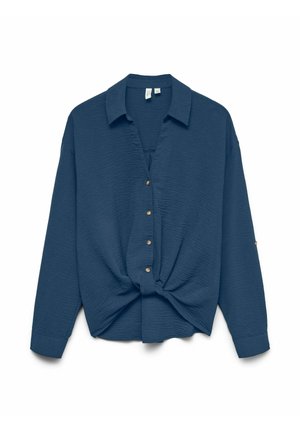 Chemise boutonnée bleu marine avec une finition texturée, un col et un détail noué à l'avant. Présente des boutons dorés et des manches longues.