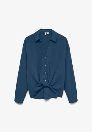 Chemise boutonnée bleu marine avec une finition texturée, un col et un détail noué à l'avant. Présente des boutons dorés et des manches longues.