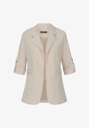 Bežs žakets ar griezumu uz atlokiem, trim ceturtdaļām piedurknēm un ruļļveida aprocēm. Iezīmētas divas priekšējās kabatas un gluda faktūra. Redzama zīmola etiķete iekšpusē.