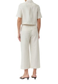Cropped short-sleeve shirt and wide-leg pants in off-white fabric with navy vertical stripes. Features subtle back pleat and dual back pockets.