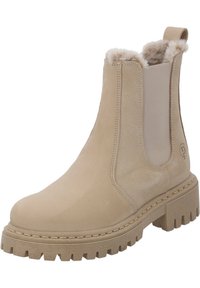 Botín beige hasta el tobillo con un exterior de cuero texturizado, paneles laterales elásticos, forro suave y una suela de goma gruesa y estriada.