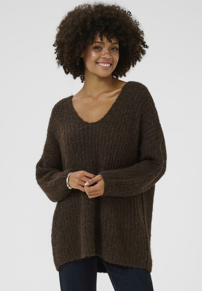 Brown fluffy knit sweater with a wide V-neck, ribbed texture, and long sleeves. Loose fit and slightly longer at the back.