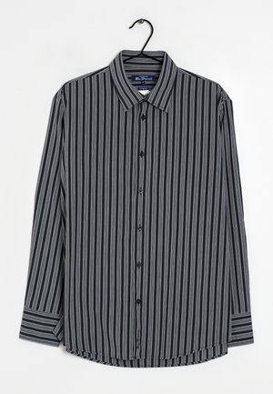 Koszula zapinana na guziki w biało-czarne paski, z niebieskimi i szarymi akcentami. Długie rękawy, widoczna faktura materiału, zaokrąglony dolny brzeg i kołnierzyk.