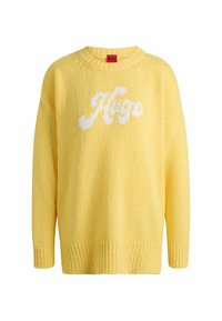 Maglione giallo a maglia con scollo ampio, polsini a costina e logo bianco "Hugo" sul davanti. Tessuto testurizzato con una vestibilità morbida.