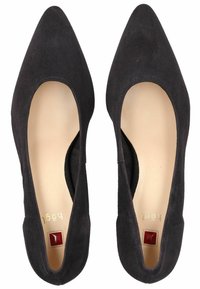 Black suede pointed-toe flats with curved cutouts on the sides and a cream interior. Features a small red accent on the insole.