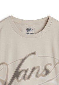 Beige cotton t-shirt featuring a faded black "Vans" logo design. Round neck with a soft texture, label indicating size "Small."