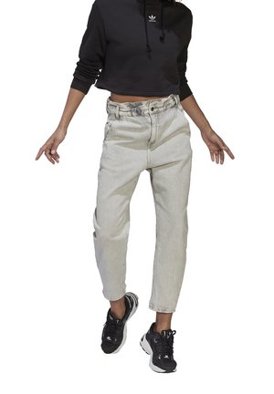 Light grey denim jeans with a high waist and relaxed fit, paired with a black cropped hoodie featuring a small white logo.