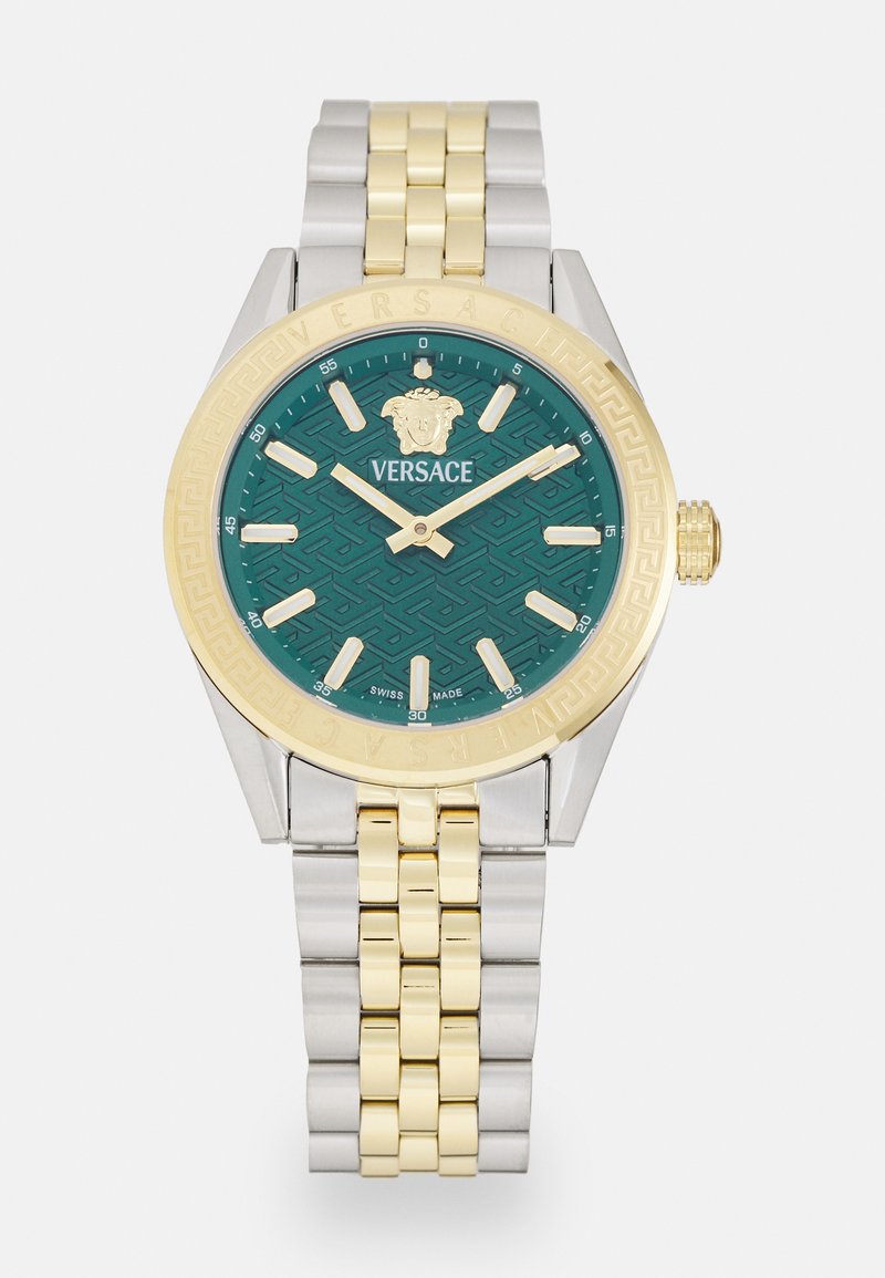 Versace kell, millel on türkiissinine mustriga kelladial, kuldne äär, hõbedast ja kuldsest metallist rihm ning logo kell 12 positsioonil. Swiss Made.