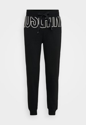 Mustad mustad püksid pehmest puuvillakangast, millel on paelaga vöökoht ja julge valge "MOSCHINO" logo ees. Värvitud pahkluu disain.