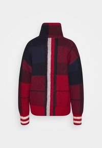 Rot-kariertes Pullover in Marineblau mit hohem Kragen, gestreiften, gerippten Bündchen und strukturiertem Wollstoff. Auffälliges vertikales weißes Streifendetail.