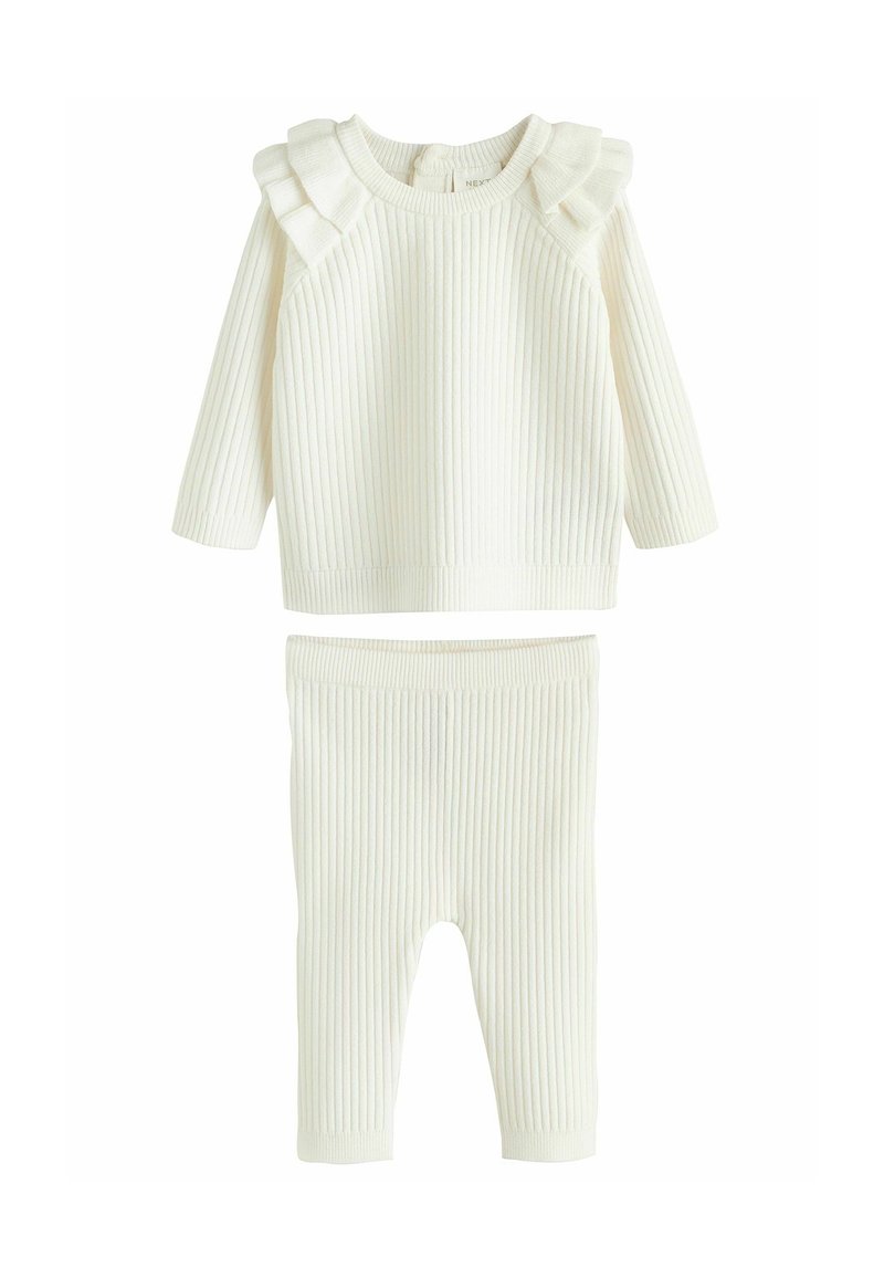 Rippstrick-Zweiteiler in Creme, bestehend aus einem Langarmoberteil mit Rüschendetails und passenden Leggings mit elastischem Bund.