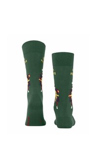 Grüne Socken mit einem gerippten Bündchen, verziert mit bunten Nussknacker-Designs und dem Text "Socken für den Winter", aus weichem Strickmaterial gefertigt.