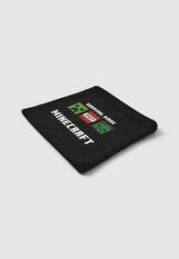 Coperta nera con un design pixelato di un creeper verde e il testo "Survival Mode" e "Minecraft" in bianco e rosso. Texture morbida.