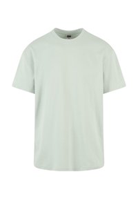 T-shirt en coton vert clair avec un col rond et des manches courtes. Design simple, texture lisse et sans motifs ni accents supplémentaires.
