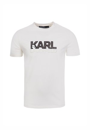 Valkoinen puuvillainen t-paita, jossa mustavalkoinen "KARL LAGERFELD" -logo kirjailtuna rintaan. Lyhyet hihat ja pyöreä pääntie.