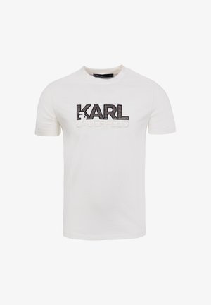 White cotton t-shirt featuring "KARL LAGERFELD" logo in black and white embroidery across the chest. Short sleeves and round neckline.
