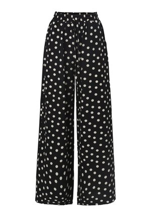 Wide-leg trousers made of soft fabric, featuring a black background with large white polka dots and an elastic waistband for comfort.