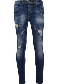 Vybledlé modré džíny skinny s poškozenými detaily a třepenými záplatami. Obsahují pět kapes a zipový poklopec s knoflíkovým uzávěrem.