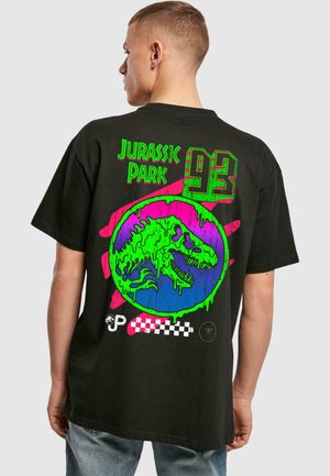 Black t-shirt featuring a vibrant graphic on the back: a green dinosaur within a blue circle, accented with pink and checkered designs.