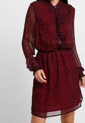Red leopard print dress made of sheer fabric, featuring a button-down front, collar, elastic waist, and long, ruffled sleeves.