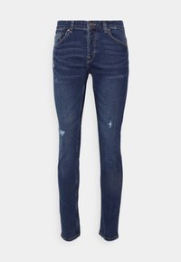Jeans ajustados de mezclilla azul oscura con una cintura de altura media, que cuentan con un ligero desgaste, detalles rasgados y un estilo de cinco bolsillos.
