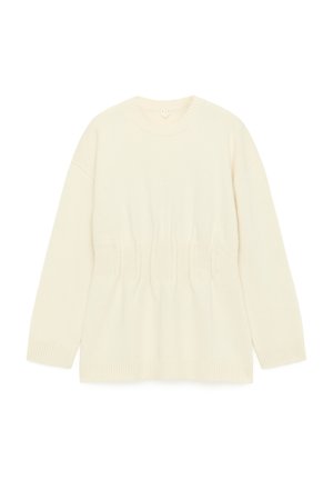 Cream-colored knit sweater with a round neckline, long sleeves, and gathered detailing at the waist. Features ribbed cuffs and hem.