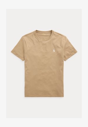 Béžové tričko s krátkým rukávem a kulatým výstřihem s malým bílým logem polového hráče na levé straně hrudi.