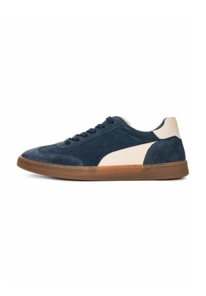 Navy suede sneakers with a cream leather accent, round toe, lace-up design, and a gum rubber sole. Side view showcases sleek silhouette.