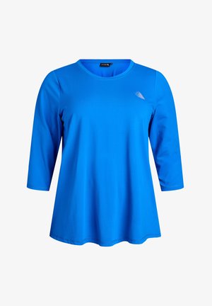 Blå långärmad tunika med rund halsringning, tillverkad i ett mjukt tyg. Har en liten logotyp i övre vänstra hörnet och en utsvängd nederdel.