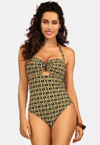 Jednoczęściowy kostium kąpielowy w kolorze czarnym z geometrycznym wzorem w odcieniach zielonego, pomarańczowego i żółtego. Model na halterze z wycięciem na środku.
