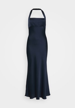 Navy halter evening gown with a fitted bodice and flowing skirt. Made of smooth fabric with a slightly shiny texture.