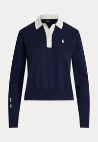 Tumesinine polo särk pikkade varrukatega, valge krae, kolmeknupuline nööbiliist, väike valge logo rinnal ning valge RLX logo vasakul varrukal.